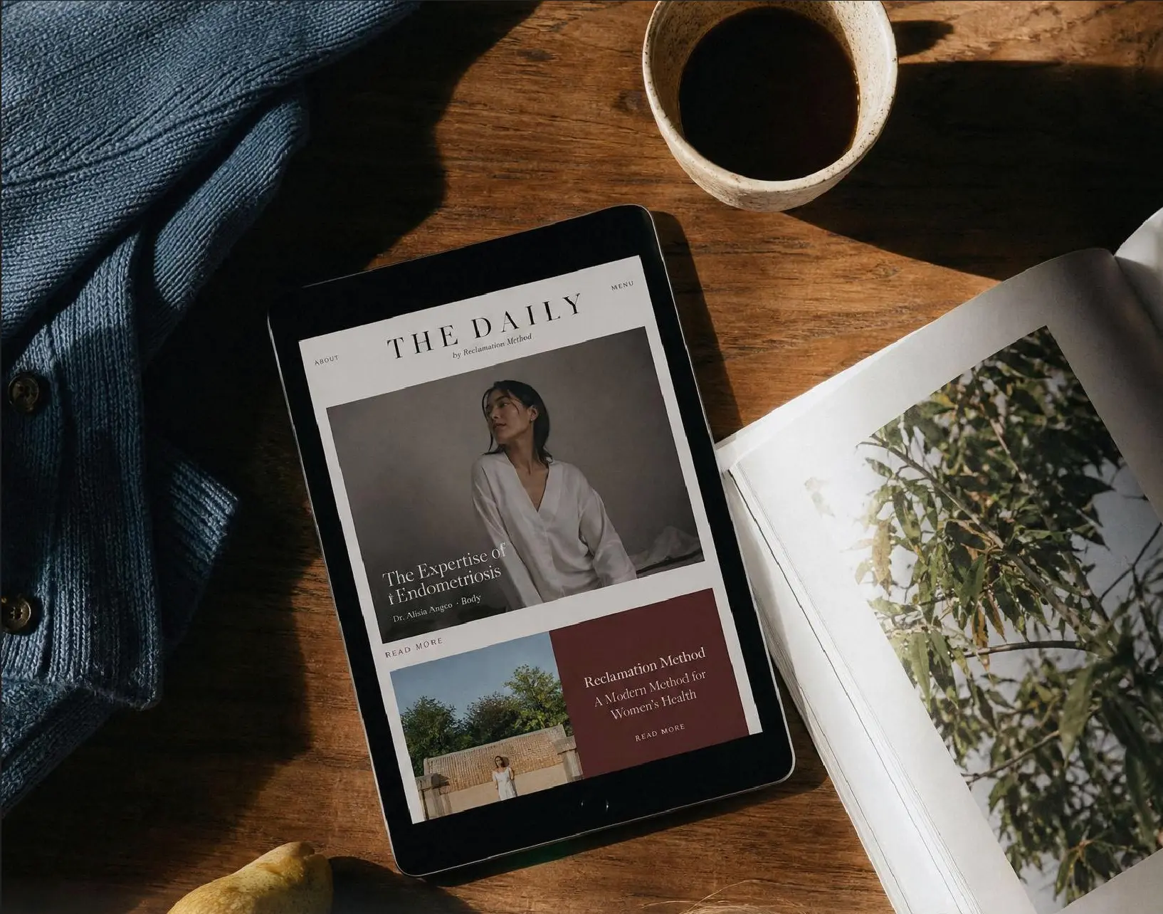 The September edition of The Daily open on a tablet beside coffee